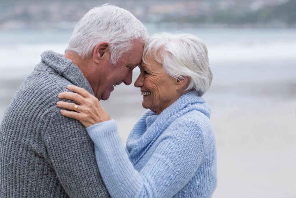 Senior couple standing together on the beach
