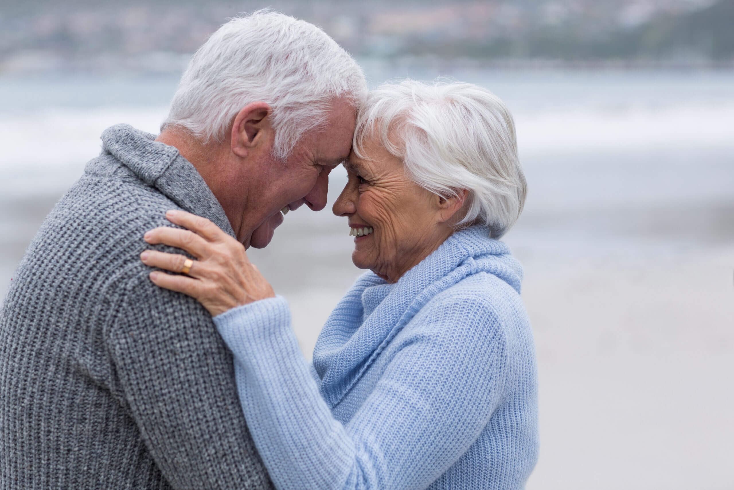Senior couple standing together on the beach